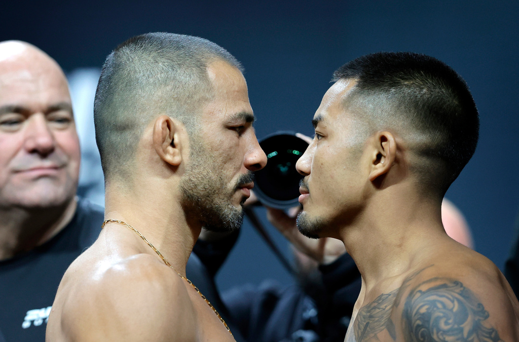 FILE - UFC flyweight champion Alexandre Pantoja, left, of Brazil, and Joshua Van, originally of Myanmar, face off during a ceremonial weigh-in for UFC 323 Friday, Dec. 5, 2025, in Las Vegas (Steve Marcus/Las Vegas Sun via AP,File)