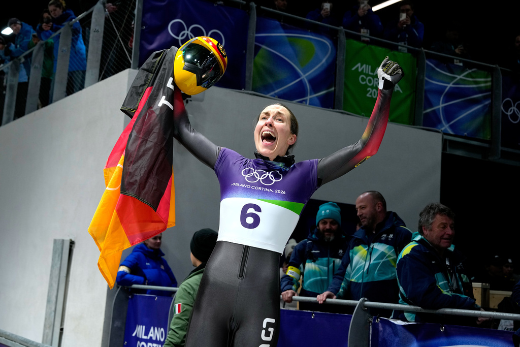 Germany's bronze medalist Jacqueline Pfeifer celebrates as she arrives at the finish during a women's skeleton run at the 2026 Winter Olympics, in Cortina d'Ampezzo, Italy, Saturday, Feb. 14, 2026. (AP Photo/Alessandra Tarantino)