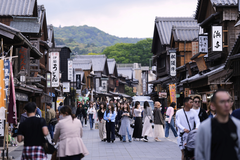 People visit a shopping street near the Ise Jingu shrine complex in Ise, central Japan, Thursday, May 1, 2025. (AP Photo/Hiro Komae)