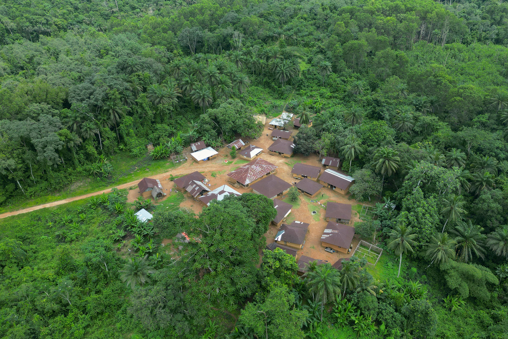 An aerial view shows a village whose residents are preparing to relocate because the river they depend on has been poisoned by mining waste, July 8, 2025, in Jikando, Liberia. (AP Photo/Misper Apawu)