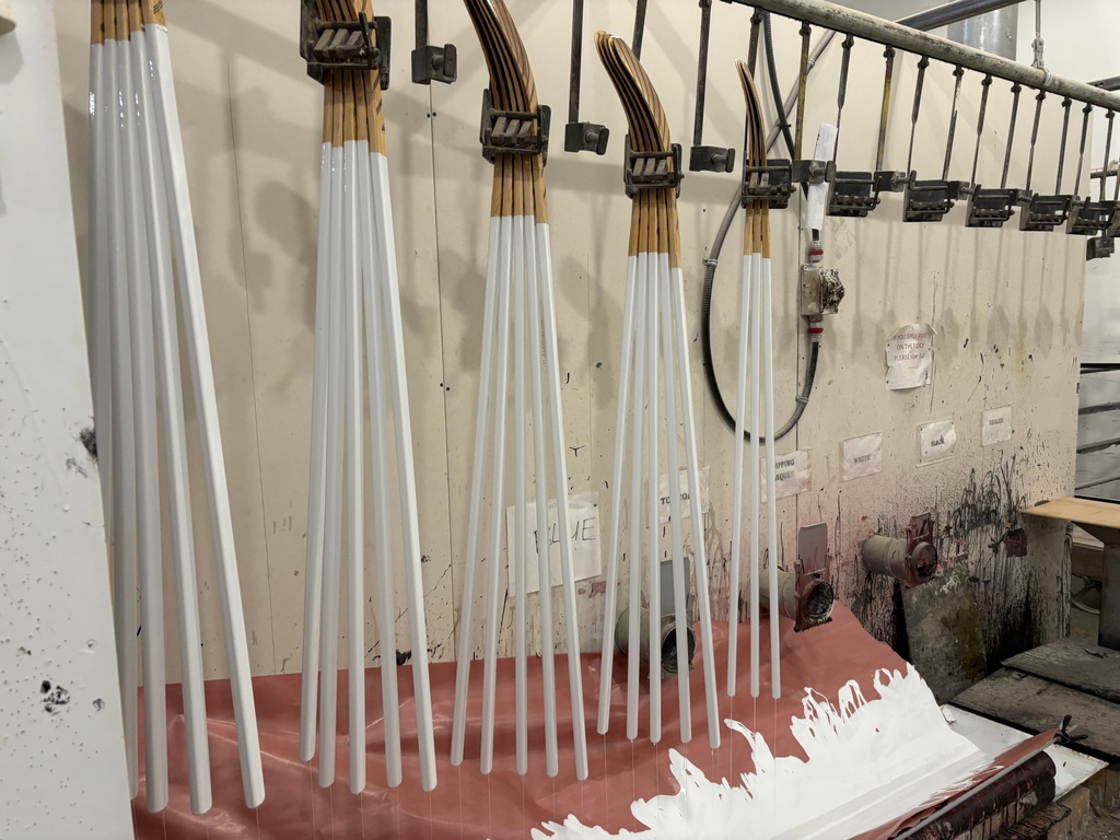 Wooden hockey sticks are stacked as they move along the assembly line at the Roustan Hockey factory, which is the last major manufacturer of hockey sticks in Canada on Aug. 27, 2025 in Brantford, Ontario. (AP Photo/Kelvin Chan)