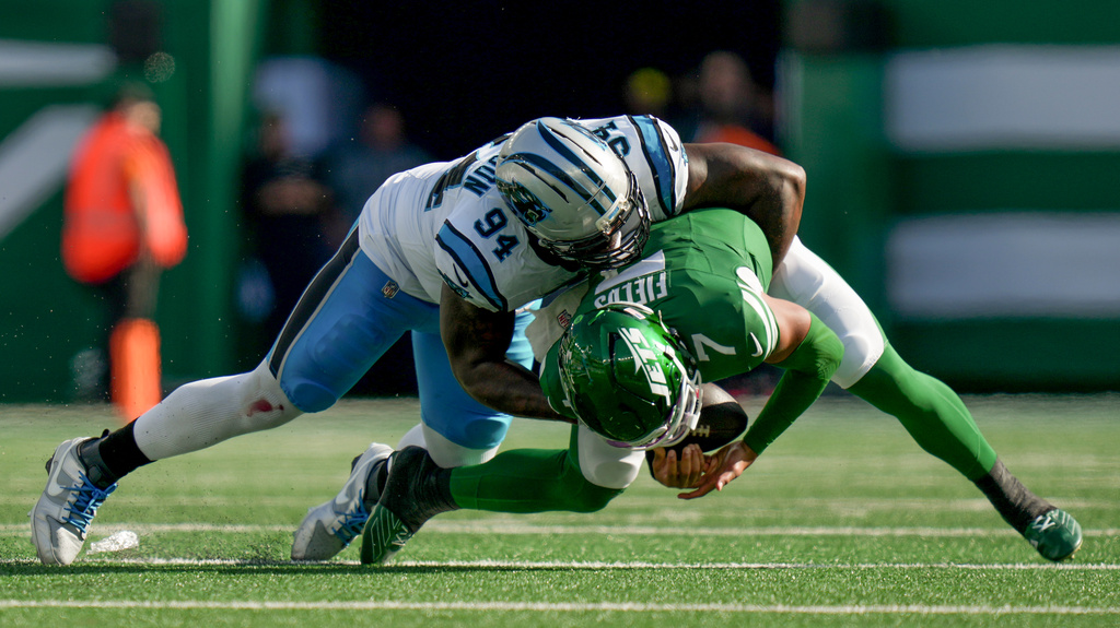 Carolina Panthers defensive end A'Shawn Robinson (94) sacks New York Jets quarterback Justin Fields (7) during the third quarter of an NFL football game, Sunday, Oct. 19, 2025, in East Rutherford, N.J. (AP Photo/Angelina Katsanis)