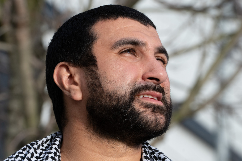 British political commentator Sami Hamdi speaks to the media in London, Thursday, Nov. 13, 2025, on his return to the U.K. after he was arrested by Immigration and Customs Enforcement on Oct. 26 while on a speaking tour in the U.S.. (AP Photo/Thomas Krych)