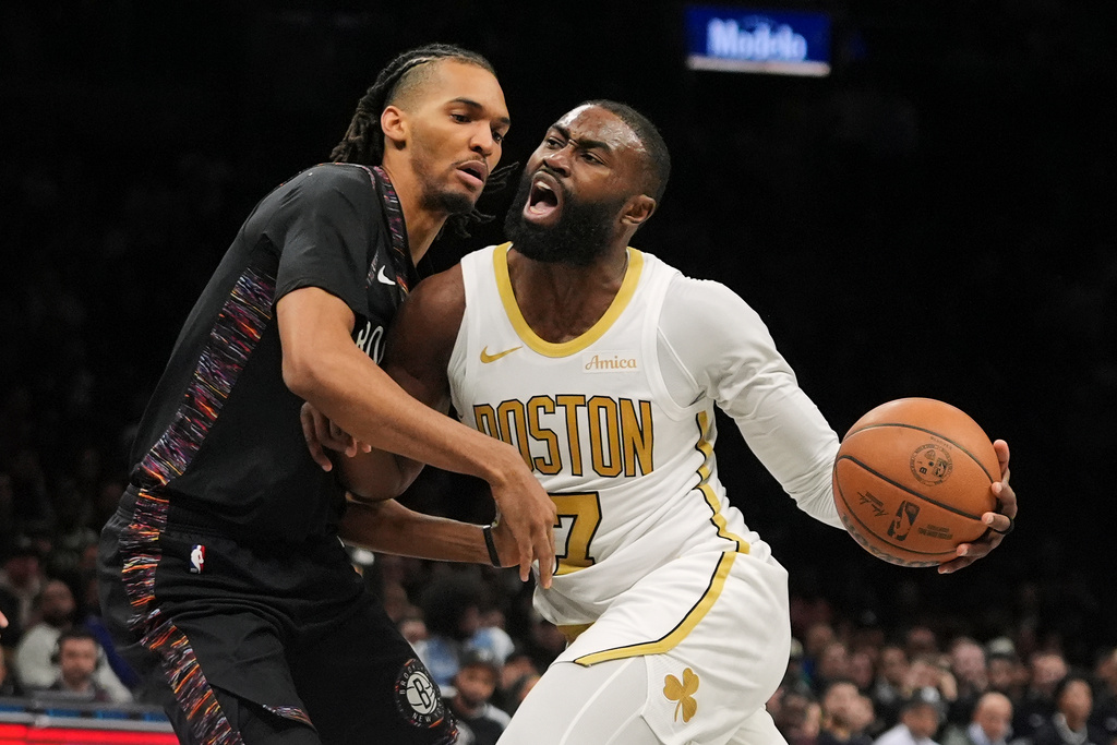 Brooklyn Nets' Ziaire Williams, left, defends Boston Celtics' Jaylen Brown during the second half of an NBA basketball game Friday, Jan. 23, 2026, in New York. (AP Photo/Frank Franklin II)