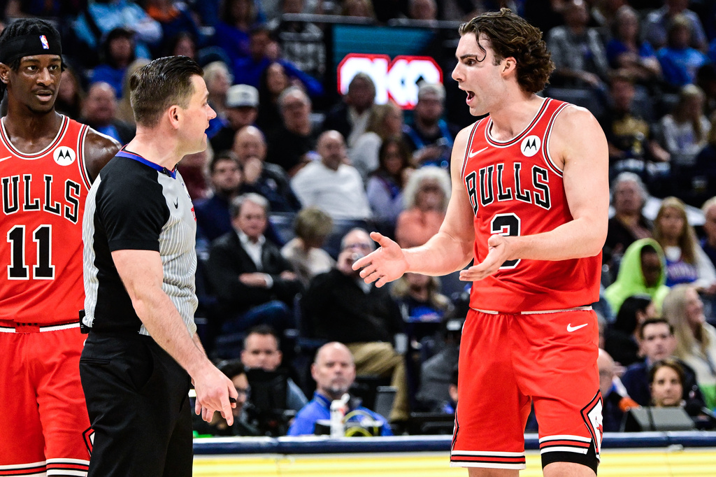 Chicago Bulls guard Josh Giddey, right, speaks with a referee during the first half of an NBA basketball game against the Oklahoma City Thunder, Friday, March. 27, 2026, in Oklahoma City. (AP Photo/Gerald Leong)