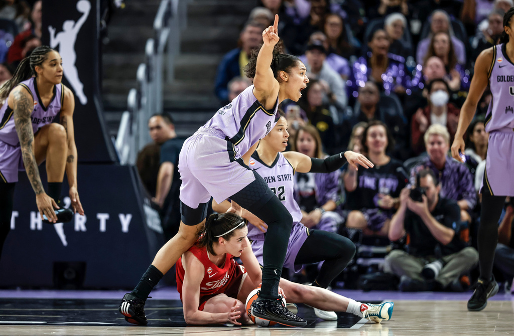 Golden State Valkyries' Janelle Salaün (13) points out a turnover to the referees by Indiana Fevers' Caitlin Clark (22) during the first half of a WNBA basketball game in San Francisco on Thursday, May 28, 2026. (Carlos Avila Gonzalez/San Francisco Chronicle via AP)