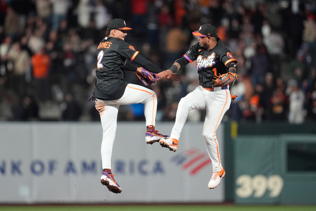 San Francisco Giants shortstop Willy Adames, left, celebrates with second baseman Luis Arraez after a baseball game against the Philadelphia Phillies in San Francisco, Tuesday, April 7, 2026. (AP Photo/Jeff Chiu)