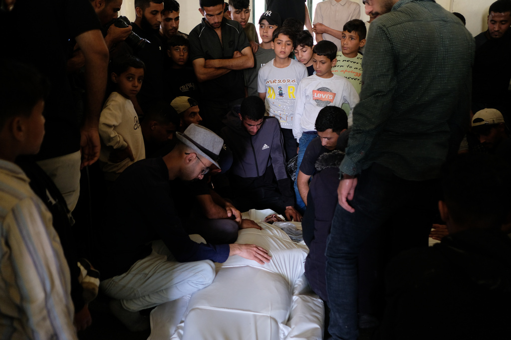 Palestinians mourn over the body of Mohammad Odeh, whom Israel says was a leader of Hamas Qassam Brigades, a day after he was killed in an Israeli airstrike, during his funeral in Gaza City, Wednesday, May 27, 2026. (AP Photo/Jehad Alshrafi)