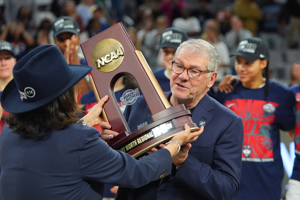 UConn head coach Geno Auriemma is presented with a Fort Worth Regional Champion trophy after his team defeated Notre Dame in the Elite Eight of the NCAA college basketball tournament, Sunday, March 29, 2026, in Fort Worth, Texas. (AP Photo/LM Otero)