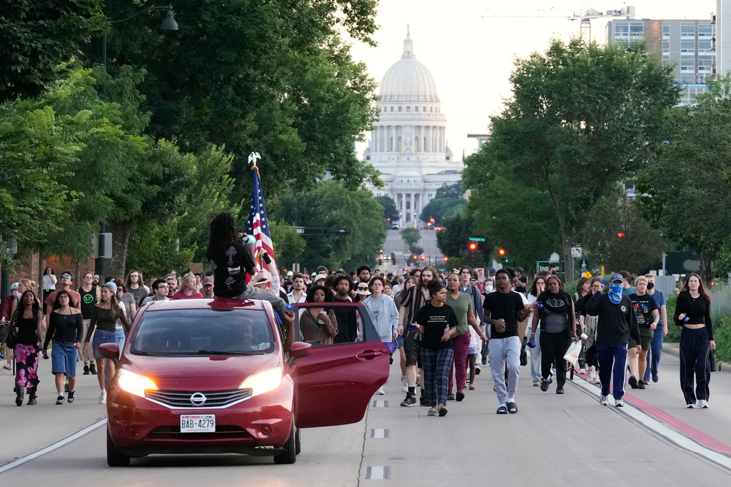 Protesters march after a Madison police officer shot and killed a man Wednesday, July 22, 2026, in Madison, Wis. (AP Photo/Kayla Wolf)
