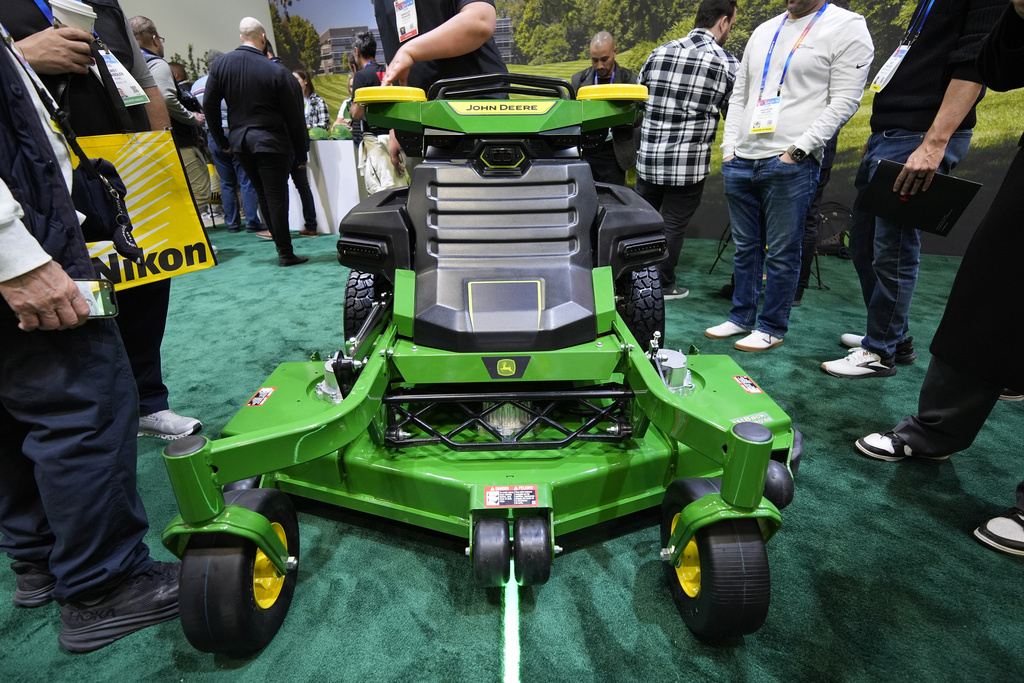 People view an autonomous lawn mower at the John Deere booth during the CES tech show Tuesday, Jan. 7, 2025, in Las Vegas. (AP Photo/John Locher)