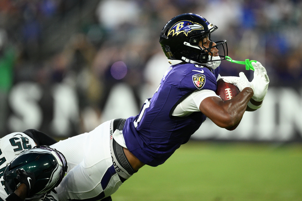 Baltimore Ravens wide receiver Ja'Kobi Lane, right, stretches to score a touchdown as he is defended by Philadelphia Eagles cornerback Michael Carter (35) during the first half of an NFL preseason football game Saturday, Aug. 15, 2026, in Baltimore. (AP Photo/Nick Wass)
