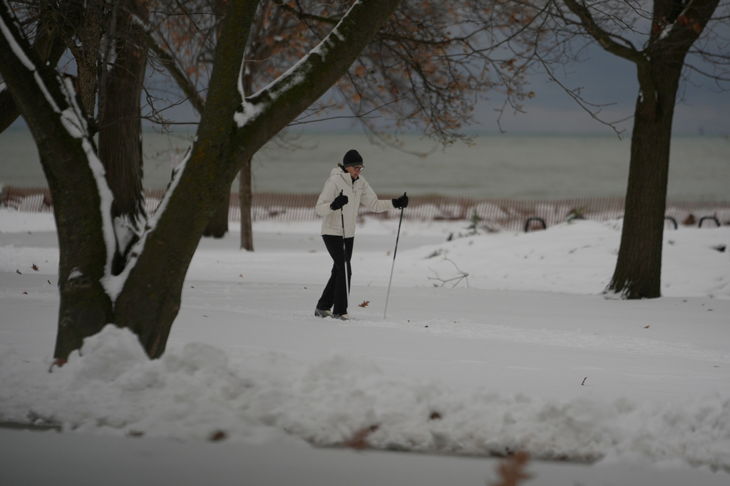 A person cross county skis in a park along Lake Michigan in Evanston, Ill., a suburb of Chicago., on Sunday, Nov. 30, 2025. (AP Photo/Kiichiro Sato)