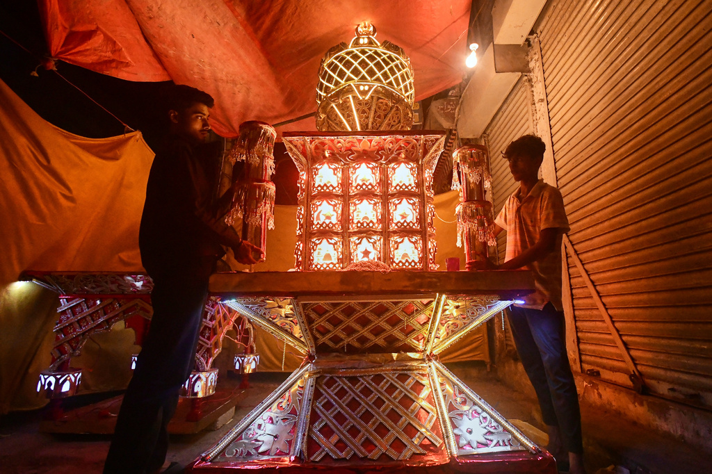 Artisans from Pakistani Hindu community, give final touches to a replica of the mausoleum of Imam Hussain locally called 'Tazia', in preparation for the upcoming Ashoura, when Shiites Muslims mark the death of Hussein, at their home in Karachi, Pakistan, Tuesday, June 23, 2026. (AP Photo/Ali Raza)