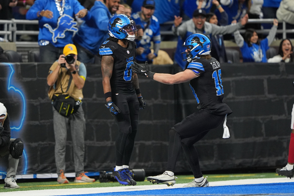 Detroit Lions running back Jahmyr Gibbs (0) celebrates his touchdown run against the New York Giants with Detroit Lions wide receiver Isaac TeSlaa (18) during overtime of an NFL football game in Detroit, Sunday, Nov. 23, 2025. (AP Photo/Ryan Sun)