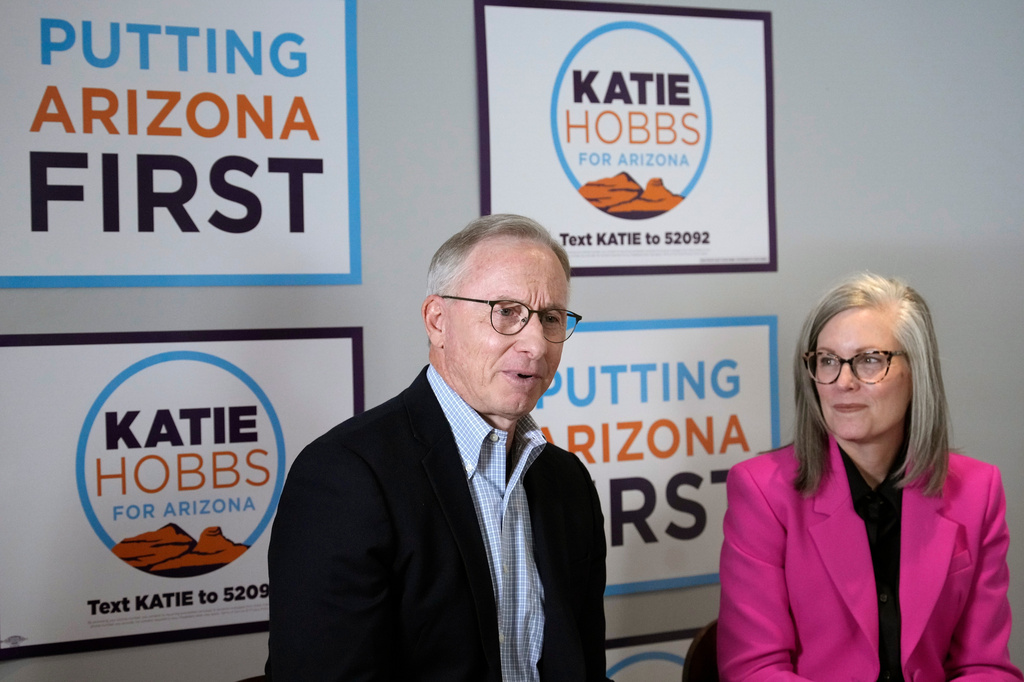 Arizona Democratic Gov. Katie Hobbs, right, listens as her running mate for Lieutenant Governor John Giles, the former Republican Mesa, Ariz., mayor, answers a question, Monday, Aug. 10, 2026, in Phoenix. (AP Photo/Ross D. Franklin)