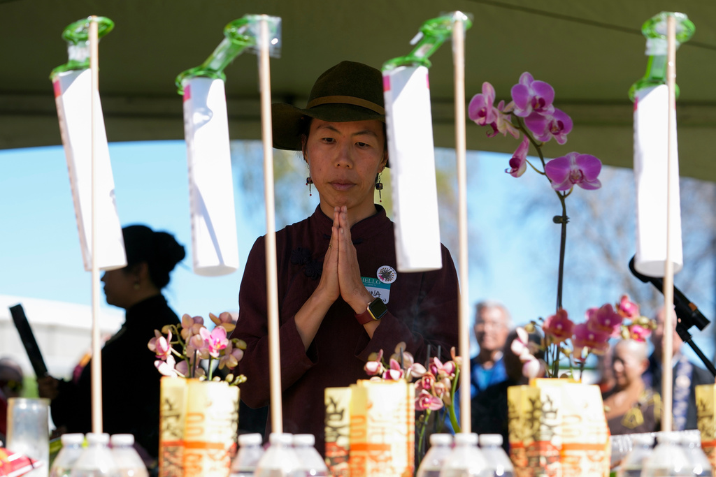 FILE - Sasanna Yee, granddaughter of Yik Oi Huang, who was fatally beaten in January 2019 in a San Francisco park, prays in front of an altar during a pilgrimage, March 16, 2024, in Antioch, Calif. (AP Photo/Godofredo A. Vasquez, File)