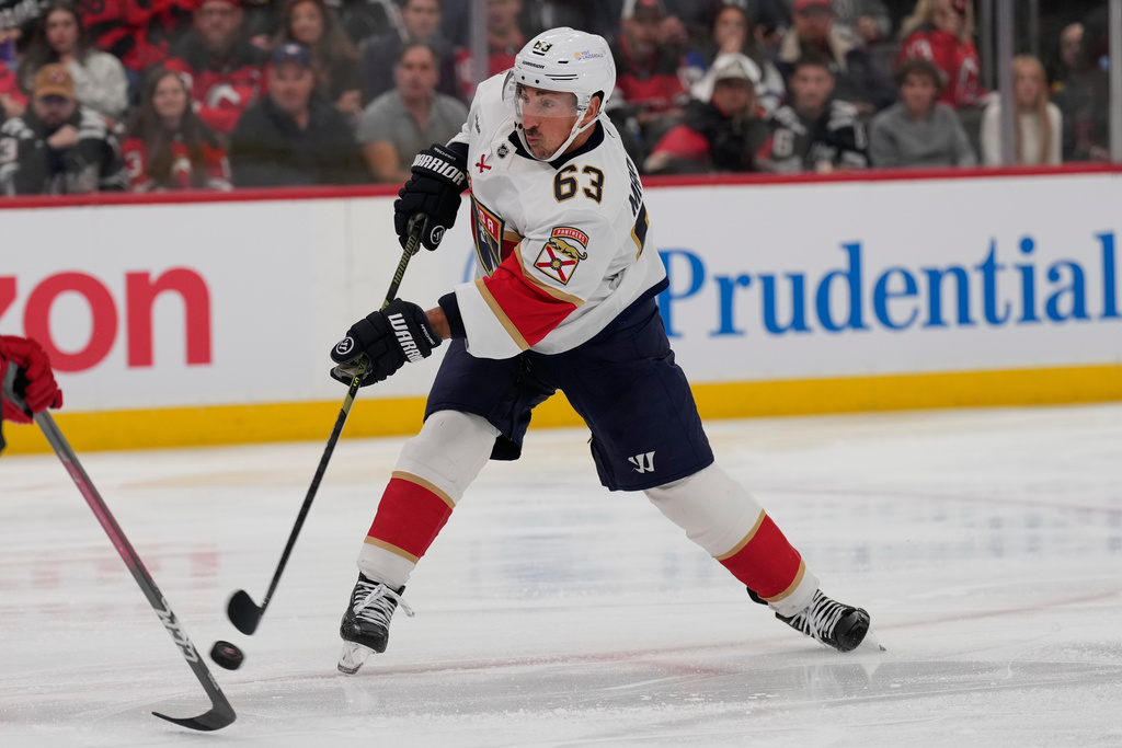 Florida Panthers' Brad Marchand takes a shot on goal during the first period of an NHL hockey game against the New Jersey Devils Thursday, Oct. 16, 2025, in Newark, N.J. (AP Photo/Seth Wenig)