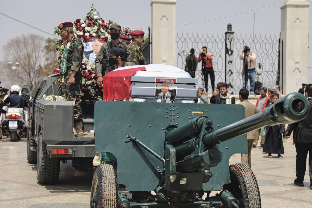 The coffin of Houthi Prime Minister Ahmed al-Rahawi, draped in a Yemeni flag, is carried on a military vehicle during his funeral procession in Sanaa, Yemen, Monday, Sept. 1, 2025. (AP Photo/Osamah Abdulrahman)
