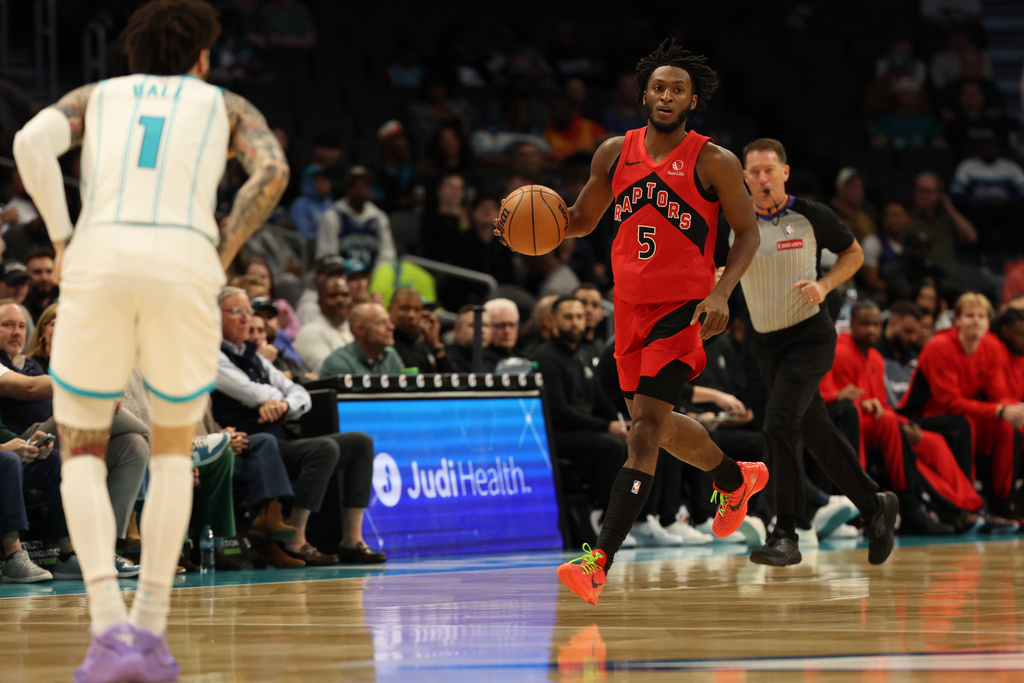 Toronto Raptors guard Immanuel Quickley (5) brings the ball up court towards Charlotte Hornets guard Lamelo Ball (1) during the first half of an NBA basketball game against the Charlotte Hornets, Wednesday, Jan. 7, 2026, in Charlotte, N.C. (AP Photo/Krista Jasso)