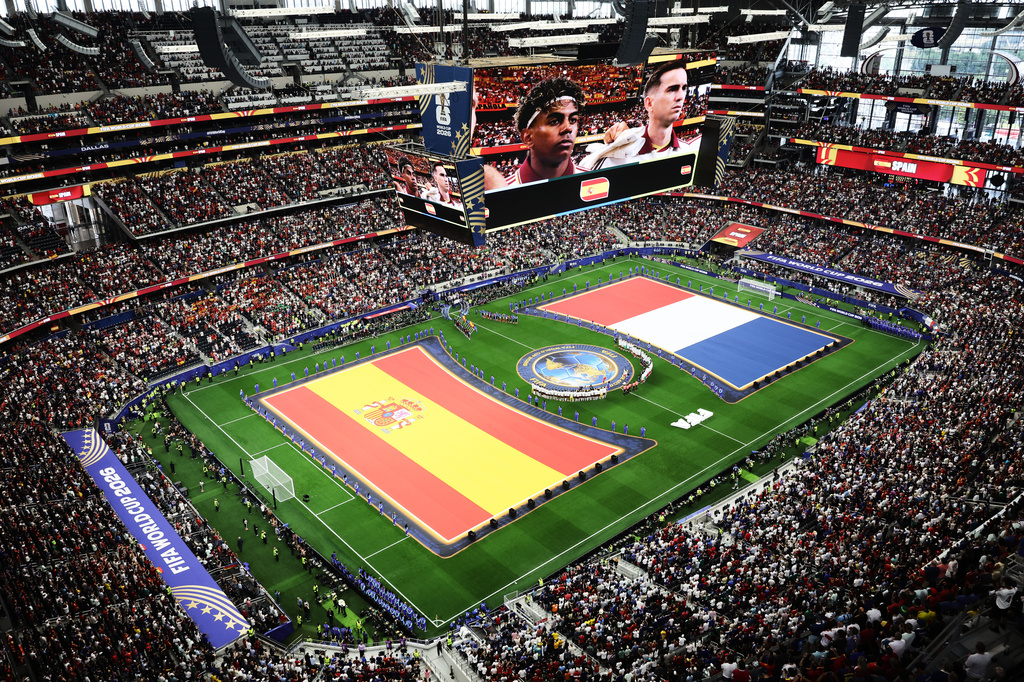 Spanish and French flags are seen on the pitch during the presentation of the teams before the World Cup semifinal soccer match between France and Spain in Arlington, Texas, near Dallas, Tuesday, July 14, 2026. (AP Photo/Sam Hodde)