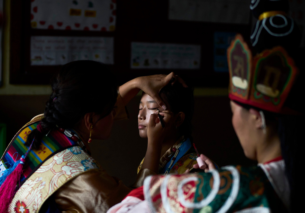 A Tibetan woman gets ready to perform at a cultural show during the 91st birthday celebration of spiritual leader the Dalai Lama in Kathmandu, Nepal, Monday, July 6, 2026. (AP Photo/Niranjan Shrestha)