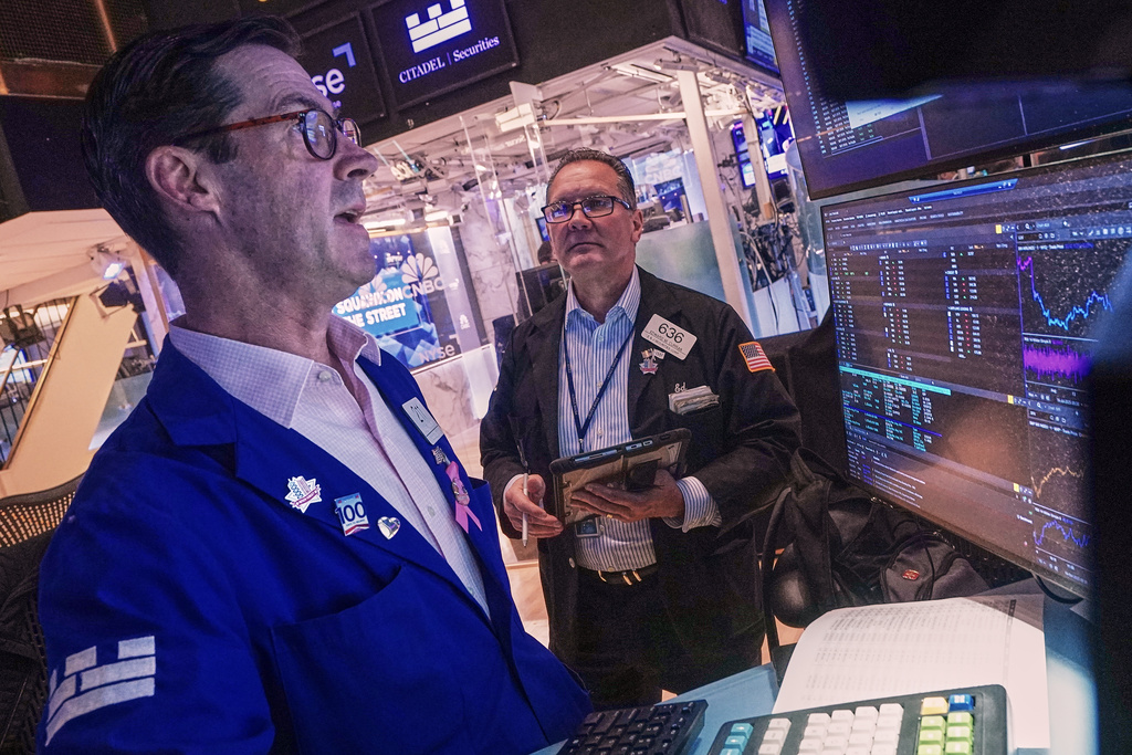Specialist John McNierney, left, and trader Edward Curran work on the floor of the New York Stock Exchange, Wednesday, Oct. 15, 2025. (AP Photo/Richard Drew)