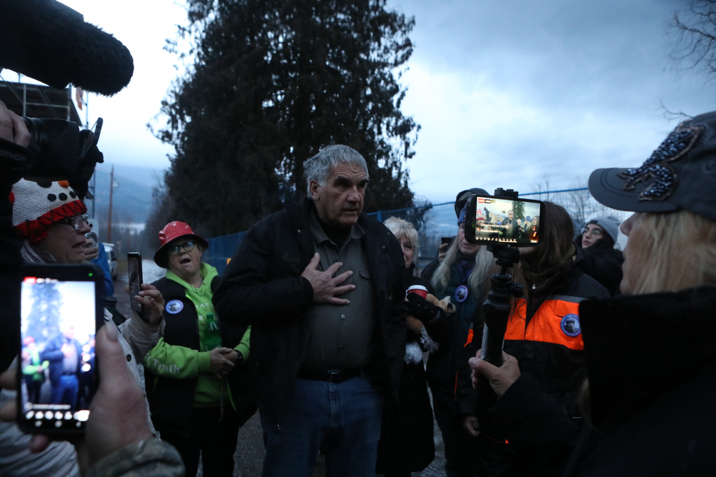 Dave Bilinski, the co-owner of Universal Ostrich Farms, announces to supporters at the farm in Edgewood, B.C., that the Supreme Court of Canada dismissed the farm's appeal to stay an order to cull more than 300 of its ostriches on Thursday, Nov. 6, 2025. (Aaron Hemens /The Canadian Press via AP)