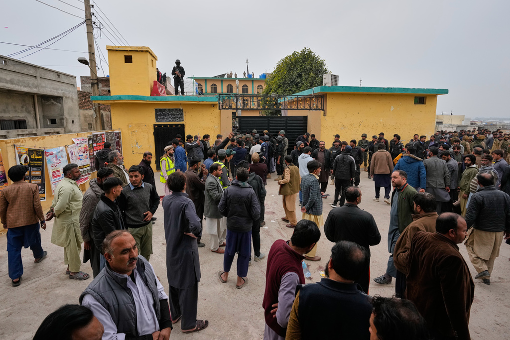 Pakistani security officers and rescue worker gather at the site of a bomb explosion at a Shiite mosque, in Islamabad, Pakistan, Friday, Feb. 6, 2026. (AP Photo/Anjum Naveed)