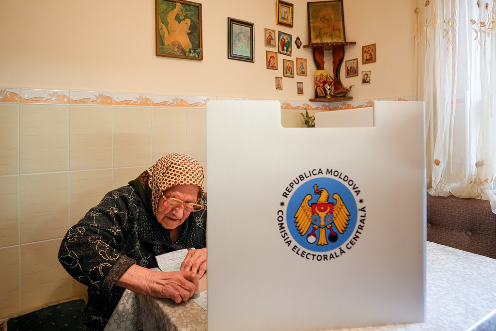 Feodora, 92 years old, casts her vote in a mobile ballot box during a parliamentary election, in Durlesti village, Moldova, Sunday, Sept. 28, 2025. (AP Photo/Vadim Ghirda)