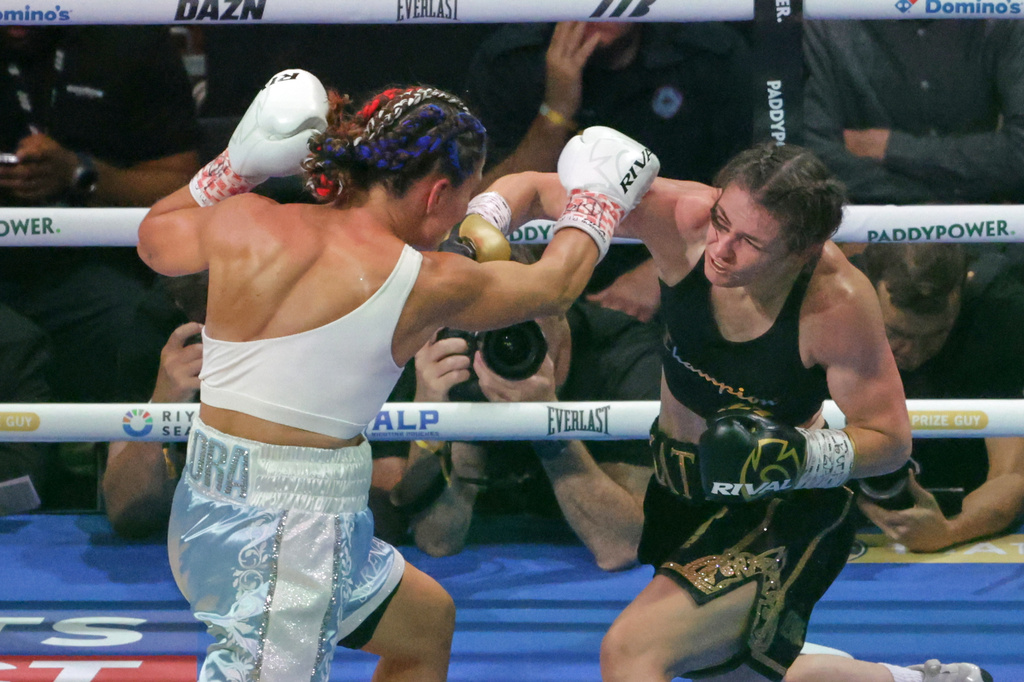 Ireland's Katie Taylor, right, and Flora Pili of France exchange blows during their super lightweight world title fight in Dublin, Saturday, Sept. 5, 2026. (AP Photo/Peter Morrison)