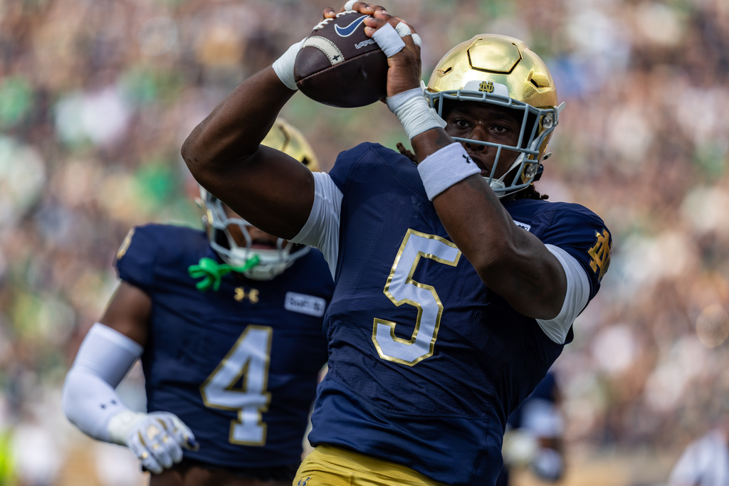 Notre Dame defensive lineman Boubacar Traore (5) recovers a fumble and returns it for a touchdown against Rice during the first half of an NCAA college football game, Saturday, Sept. 12, 2026, in South Bend, Ind. (AP Photo/Paul Barnick)