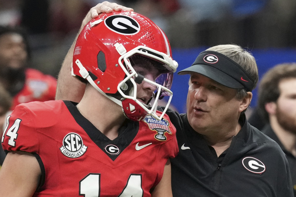 FILE - Georgia head coach Kirby Smart speaks to quarterback Gunner Stockton (14) before the Sugar Bowl NCAA college football playoff quarterfinal game against Mississippi, Jan. 1, 2026, in New Orleans. (AP Photo/Matthew Hinton, file)