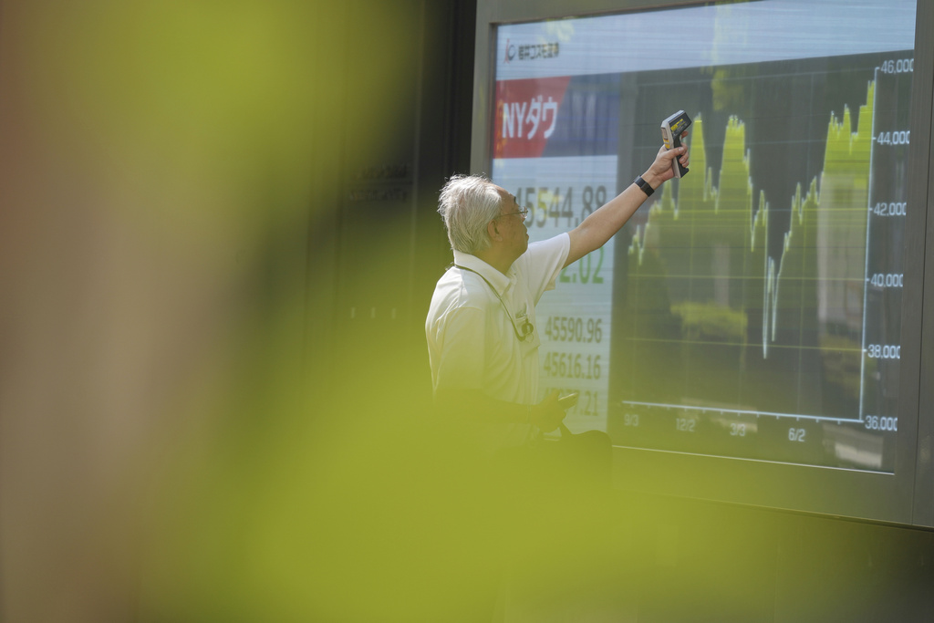 A staff check an electronic stock board prior to the opening of the stock market of the day at a securities firm Monday, Sept. 1, 2025, in Tokyo. (AP Photo/Eugene Hoshiko)