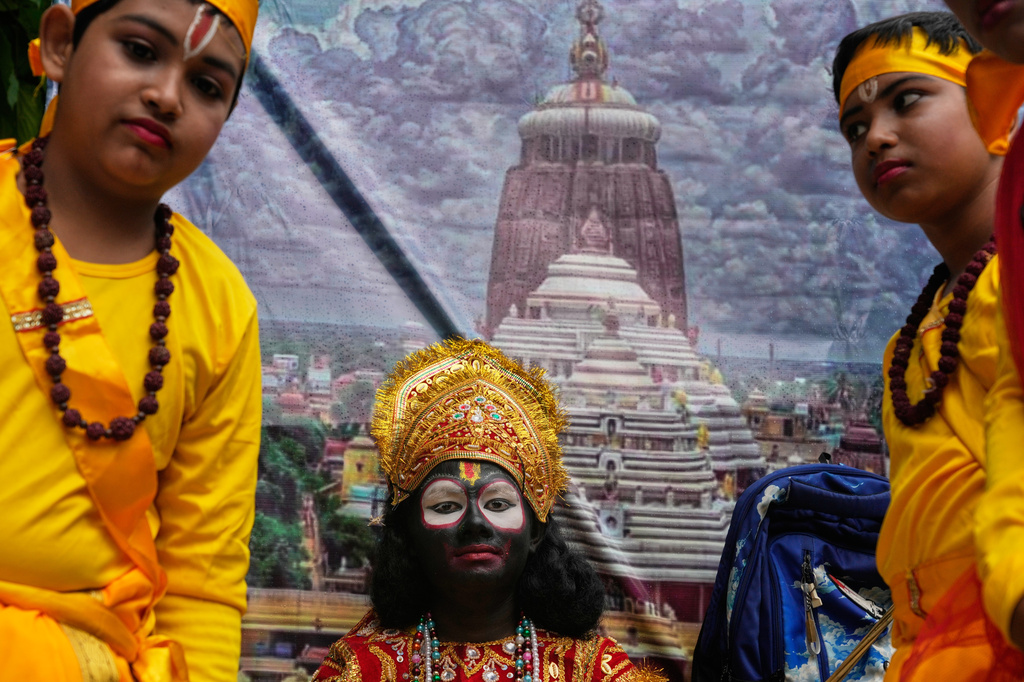 A child, centre, dressed as Hindu deity Jagannath travel on a chariot as they participate in a religious procession during the Rath Yatra, or chariot festival, carrying the Hindu deities of Jagannath, Balaram and Subhadra, in Kolkata, India, Thursday, July 16, 2026. (AP Photo/Bikas Das)