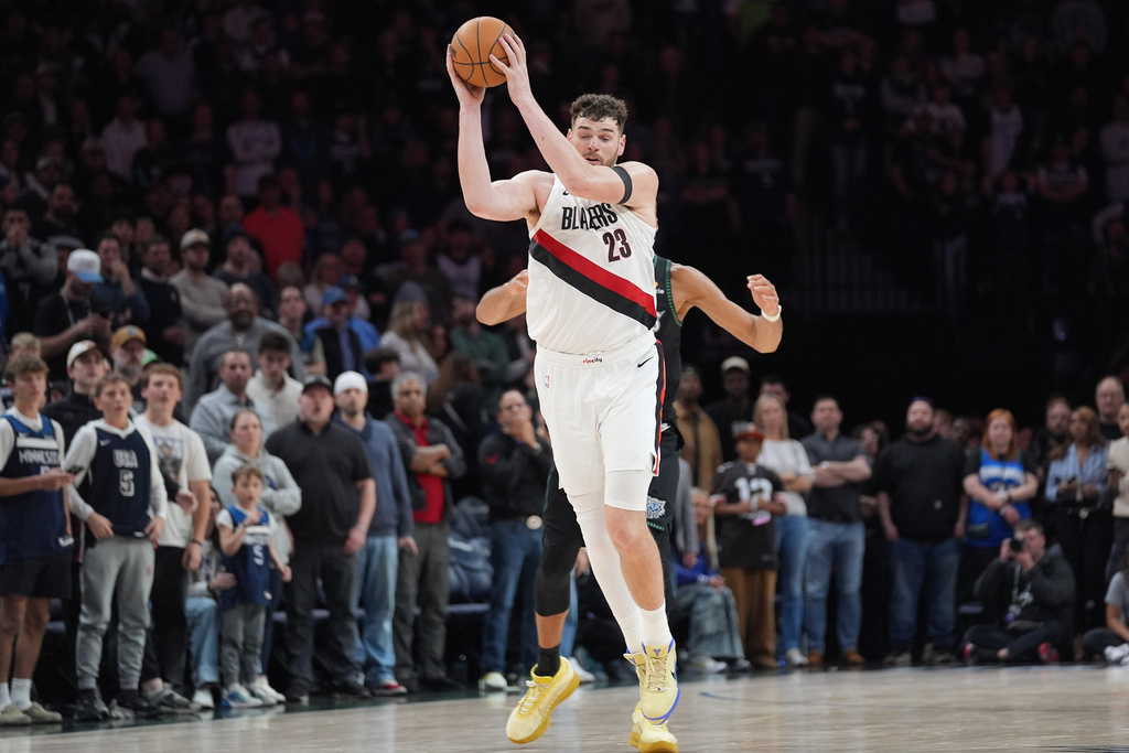 Portland Trail Blazers center Donovan Clingan (23) intercepts a pass intended for Minnesota Timberwolves center Rudy Gobert (27) during the second half of an NBA basketball game Friday, March 20, 2026, in Minneapolis. (AP Photo/Abbie Parr)