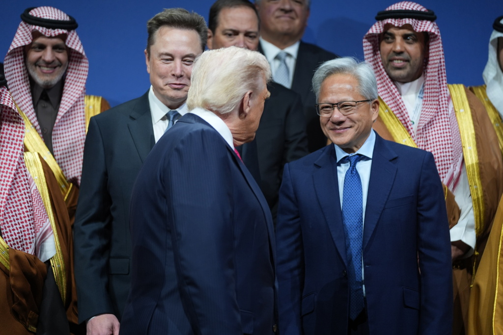 FILE - President Donald Trump speaks with Elon Musk and Nvidia CEO Jensen Huang, during the Saudi Investment Forum at the Kennedy Center, Nov. 19, 2025, in Washington. (AP Photo/Evan Vucci, File)