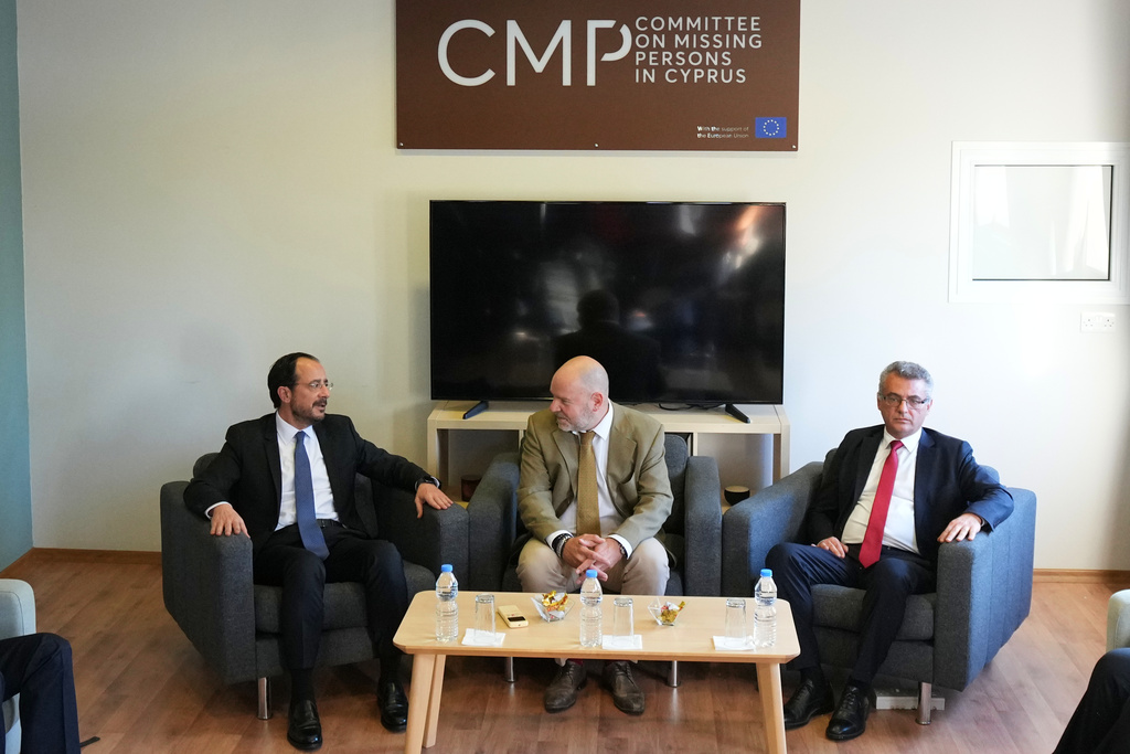Cyprus President Nikos Christodoulides, left, and Turkish Cypriot leader Tufan Erhurman, right, meet with the UN third member of the tripartite Committee on Missing Persons in Cyprus Pierre Gentile at a U.N compound inside the UN-controlled buffer zone in the island's divided capital Nicosia, on Thursday, Dec. 11. 2025. (AP Photo/Petros Karadjias, Pool)