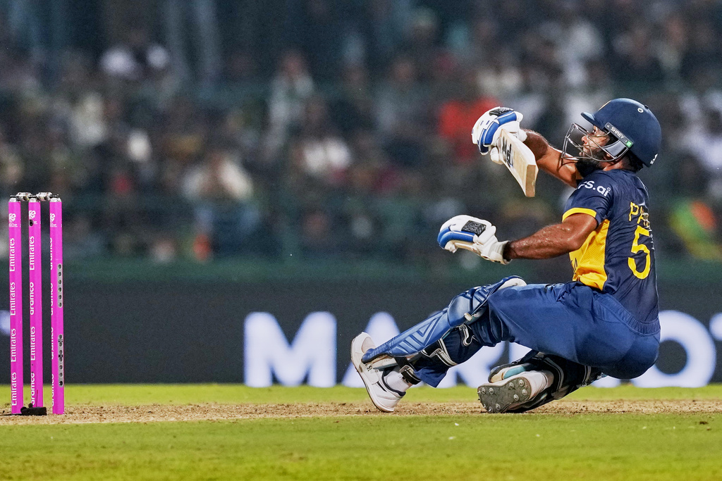 Sri Lanka's Pavan Rathnayake loses his balance while playing a shot during the T20 World Cup cricket match between Pakistan and Sri Lanka in Pallekele, Sri Lanka, Saturday, Feb. 28, 2026. (AP Photo/Eranga Jayawardena)