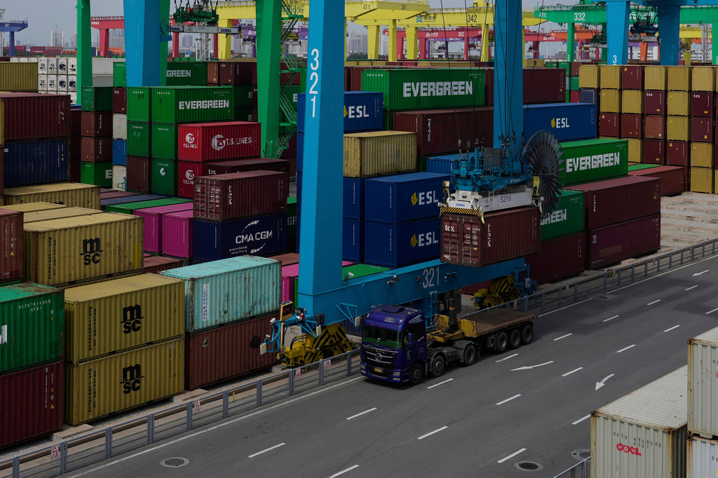 FILE - A crane loads a shipping container into a truck at an automated container port in Tianjin, China, Friday, Aug. 29, 2025. (AP Photo/Mahesh Kumar A., File)
