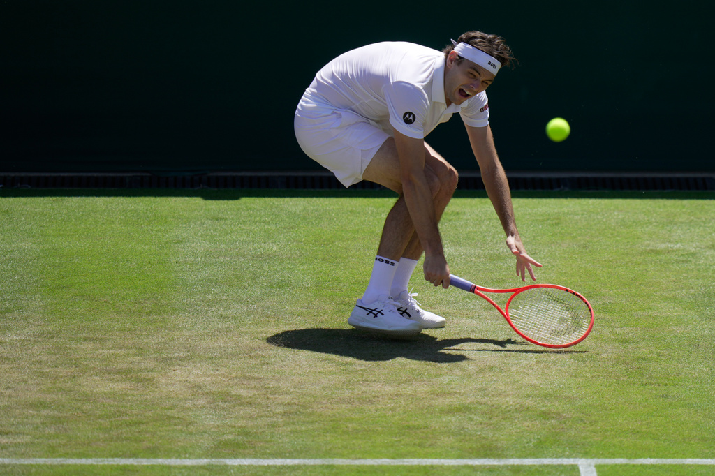 Taylor Fritz of the United States returns the ball to Patrick Kypson of the United States in their second round men's singles match at the Wimbledon Tennis Championships in London, Thursday, July 2, 2026. (AP Photo/Brian Inganga)