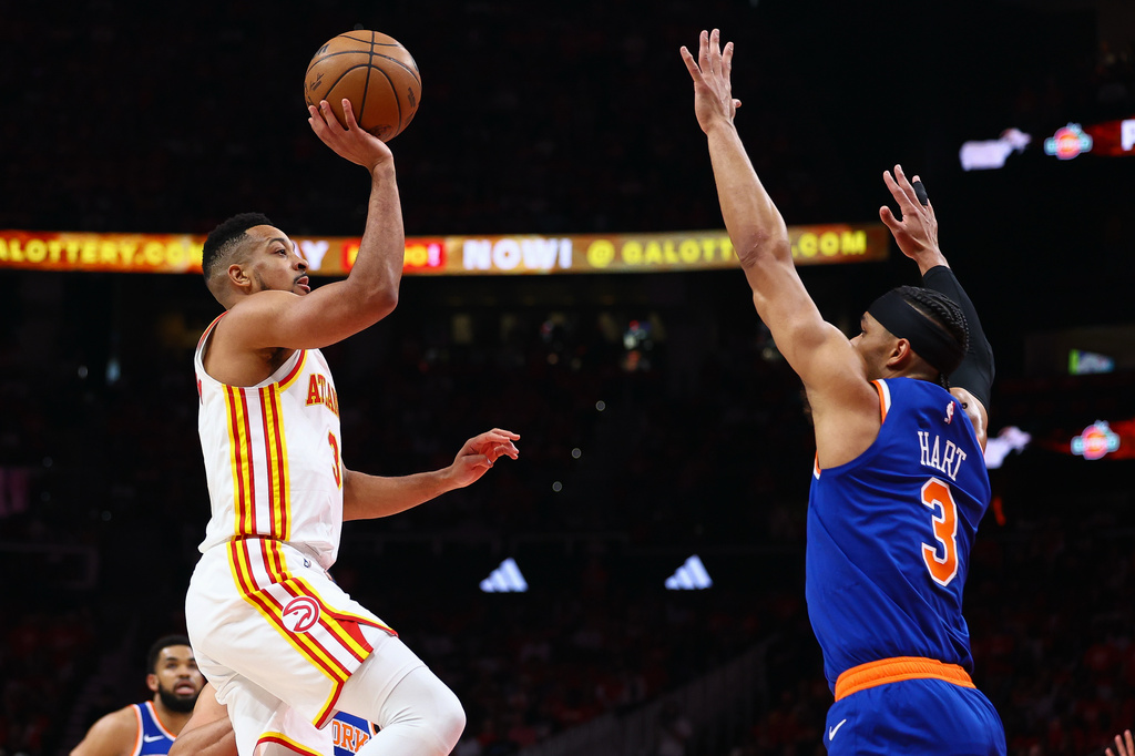 Atlanta Hawks guard CJ McCollum, left, shoots against New York Knicks guard Josh Hart, right, during the first half in Game 3 of a first-round NBA playoffs basketball series, Thursday, April 23, 2026, in Atlanta. (AP Photo/Colin Hubbard)