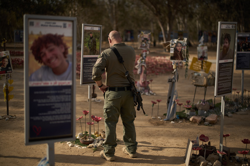 An Israeli soldier visits the site where revellers were killed and kidnapped on Oct. 7, 2023, cross-border attack by Hamas militants at the Nova music festival near the Kibbutz Reim, southern Israel, Monday, Oct. 6, 2025. (AP Photo/Leo Correa) An Israeli soldier visits the site where revellers were killed and kidnapped on Oct. 7, 2023, cross-border attack by Hamas militants at the Nova music festival near the Kibbutz Reim, southern Israel, Monday, Oct. 6, 2025. (AP Photo/Leo Correa)