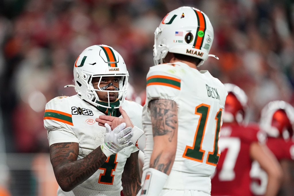 Miami running back Mark Fletcher Jr. celebrates after scoring with quarterback Carson Beck during the second half of the College Football Playoff national championship game against Indiana, Monday, Jan. 19, 2026, in Miami Gardens, Fla. (AP Photo/Rebecca Blackwell)