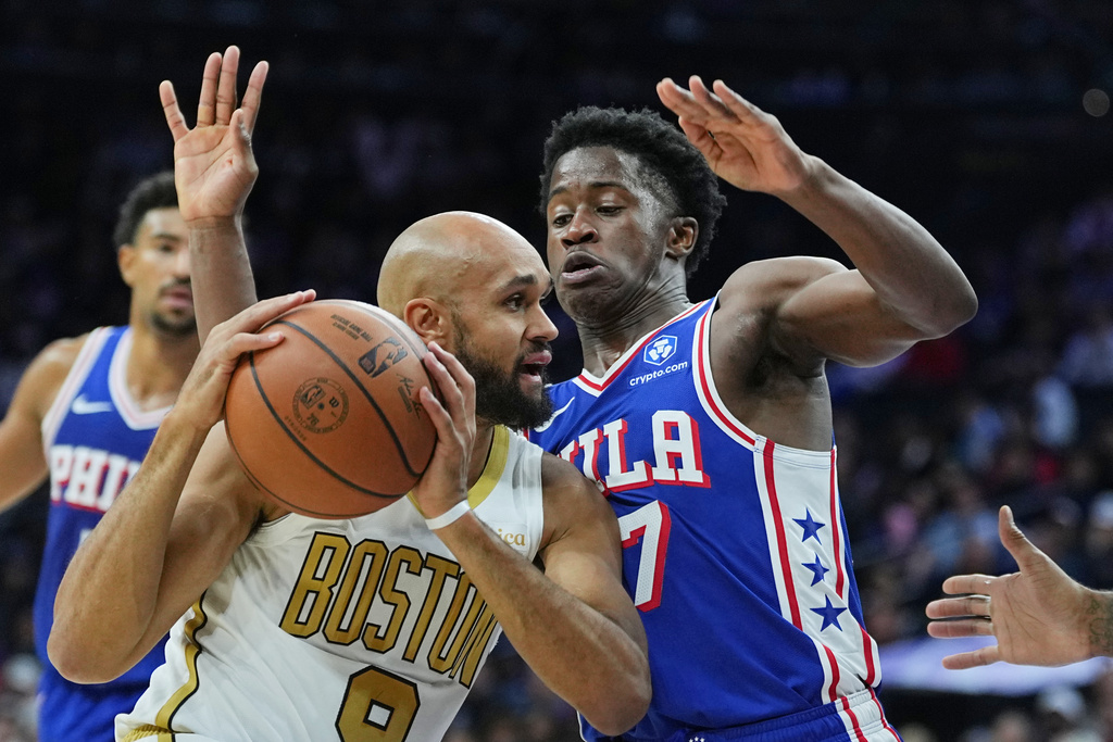 Boston Celtics' Derrick Whiten goes up to shoot against Philadelphia 76ers' Kyle Lowry during the first half of an NBA basketball game Tuesday, Nov. 11, 2025, in Philadelphia. (AP Photo/Matt Rourke)