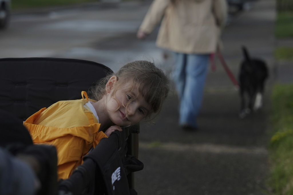 FILE - Eliza Ethridge, 5, rides in a wagon during a walk with her family, April 10, 2025, in Evansville, Ind. (AP Photo/Joshua A. Bickel, File)