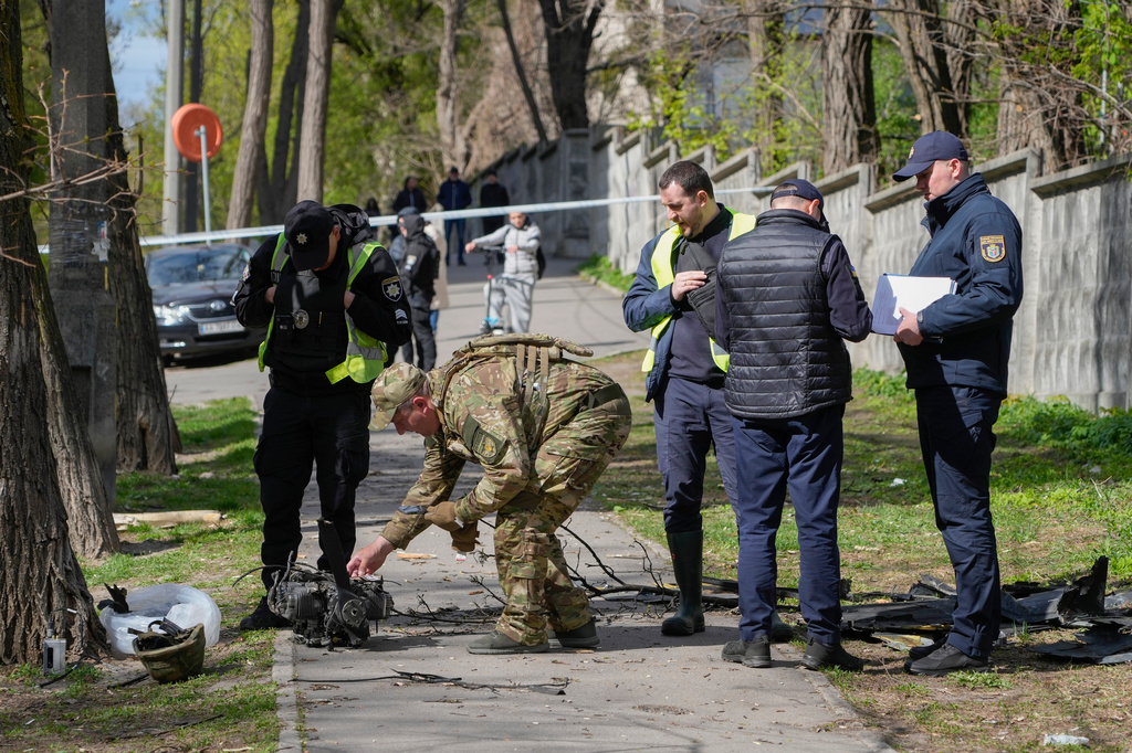 Police officers inspect fragments of a Russian drone after an air attack in Kyiv, Ukraine, Tuesday, April 28, 2026. (AP Photo/Efrem Lukatsky)
