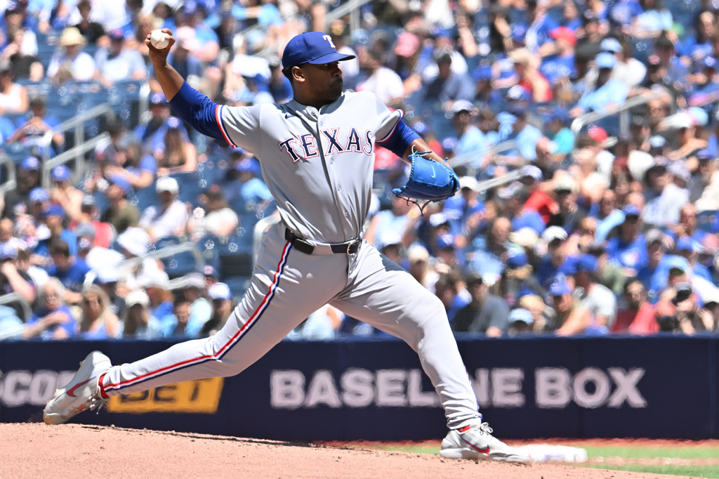 Texas Rangers starting pitcher Kumar Rocker throws to a Toronto Blue Jays batter during the first inning of a baseball game in Toronto, Sunday, June 28, 2026. (Jon Blacker/The Canadian Press via AP)