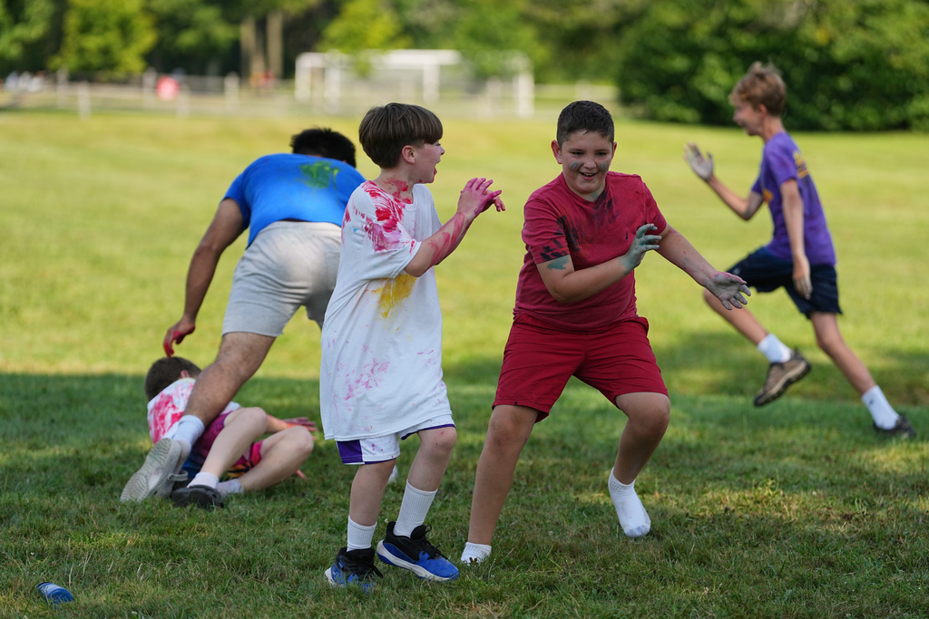 Ethan Blanchfield-Killeen, 11, center right, of Yonkers, N.Y., who has a form of juvenile idiopathic arthritis, plays a game of paint tag at the Frost Valley YMCA sleepaway camp in Claryville, N.Y., Wednesday, July 30, 2025. The camp partnered with Children's Hospital at Montefiore so kids with autoimmune diseases could attend for the first time. (AP Photo/Matt Rourke)