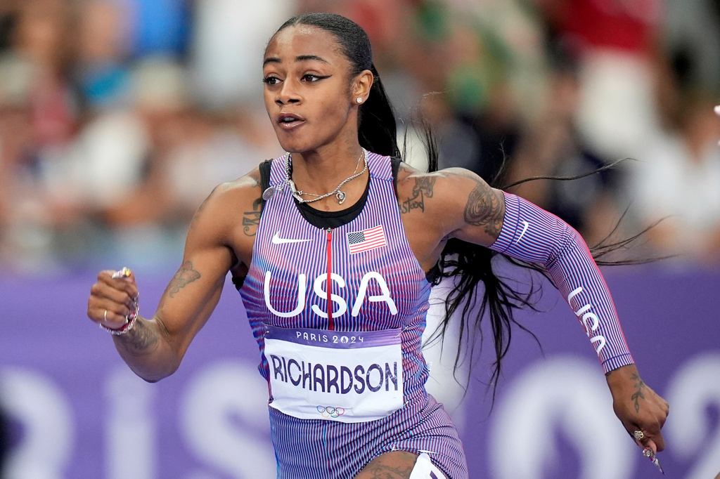 FILE - Sha'carri Richardson, of the United States, competes in the women's 100-meter semifinals at the 2024 Summer Olympics, on Aug. 3, 2024, in Saint-Denis, France. (AP Photo/Matthias Schrader, File)